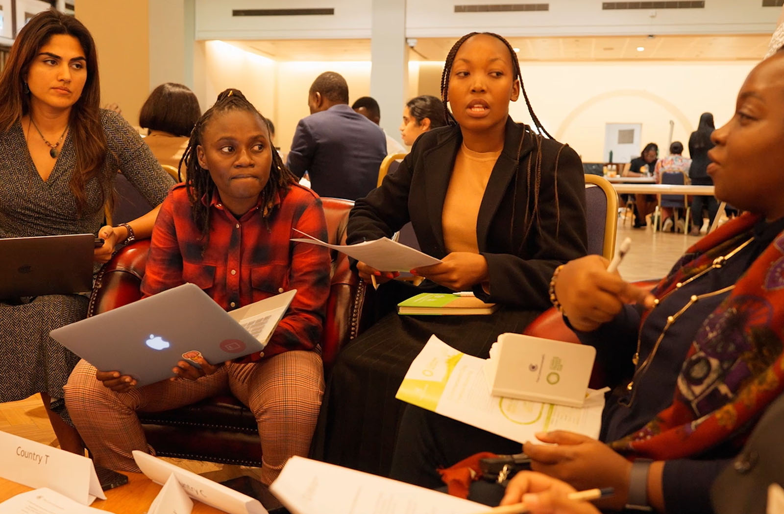 four young people talking in a group 